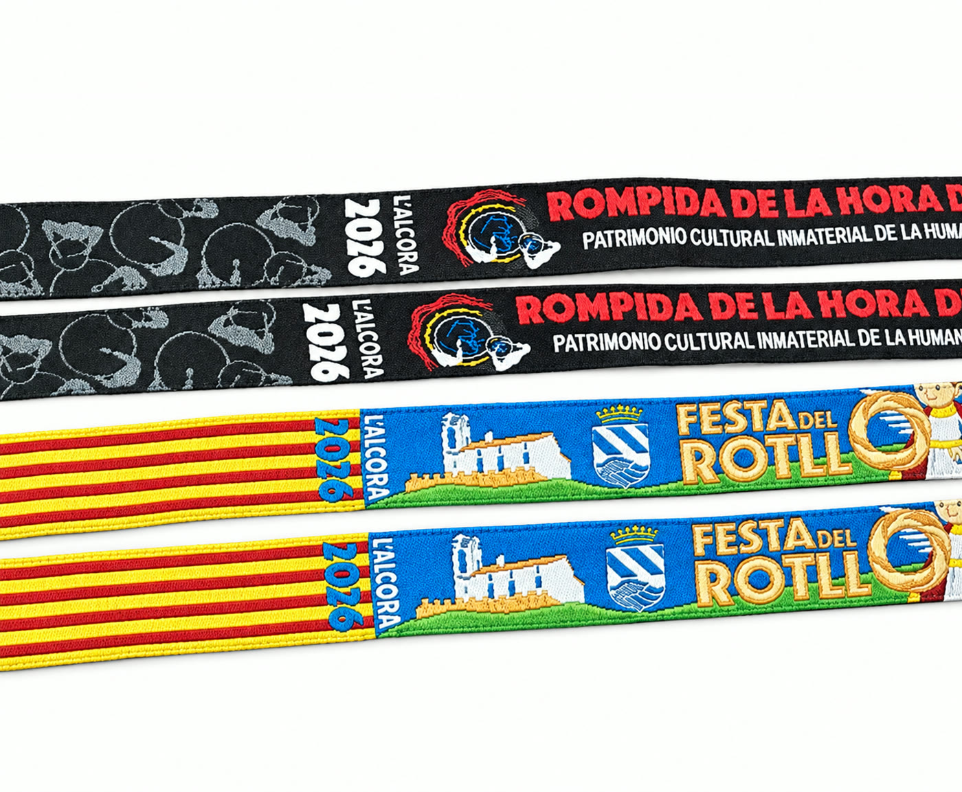 Cuatro pulseras de tela tejidas para L'Alcora 2026, con los diseños de la Rompida de la Hora y la Festa del Rotllo